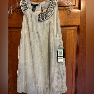 Sleeveless  silver top with unique Embellishments. Size large